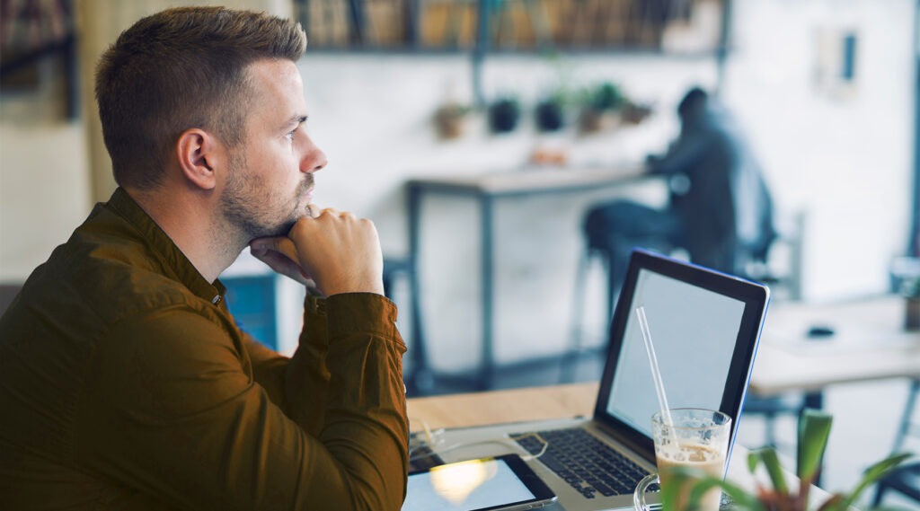 a-man-sitting-in-front-of-his-laptop-thinking-about-business